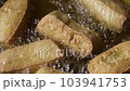 Deep-frying tofu in boiling oil. vegan and vegetarian food 103941753