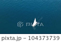 An aerial view of the sail yacht on the blue sea. Transparent clear water in the sea. 104373739