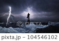 The businessman stands in the middle of a lightning ocean. The concept of a world crisis of business problems and depression in the business world. 104546102