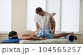 An Adult Man Trains Muscle Strength With a Professional Doctor in a Modern Rehabilitation Clinic. Physiotherapy Program, Rehabilitation After Medical Injuries. Healthcare Concept 104565257