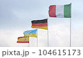 Flags of Italy, Germany, Ukraine, Spain waving in wind on blue sky background, closeup 104615173