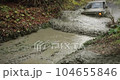 An SUV drives into a puddle at high speed off-road 104655846