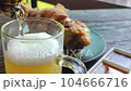 Cold beer on wooden table for dinner.  4k resolution  104666716