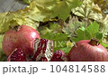 Two fresh ripe pomegranates and one cut on yellow autumn leaves 104814588