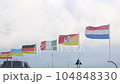 Flags of Spain, Italy, Sicily, Germany, France, Ukraine waving in wind, blue sky background, closeup 104848330