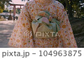 Obi of the back of a yukata woman walking on the approach to a shrine 104963875