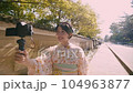 Yukata woman introducing sightseeing spots while walking with V-log selfie 104963877