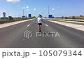 Athletic man skipping fancily with a jump rope. 105079344