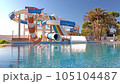 Empty small aquapark sliders with pool and palm trees at the morning, Tunisia 105104487