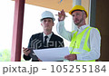 A team of engineers is discussing the structure to validate the building under construction. High quality 4k footage 105255184