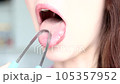 Close-up Of A Woman Cleaning Her Tongue With Cleaner. Oral Health and Fresh Breath 105357952