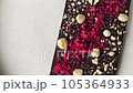 Top view of chocolate with nuts and berries . High quality 4k footage 105364933