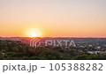 Time-lapse summer evening, sunset over village on hilly area in Greece. Warm bright sun sets below horizon and dusk falls, lights turn on in small houses. Evening to night timelapse transition 105388282