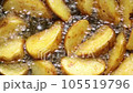 Crispy potato wedges are fried in boiling oil. Top view shots 105519796