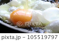 Close-up of raw egg yolk are fried in boiling oil. 105519797