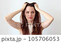Beautiful woman gives head and hair massage to improve blood circulation, hair growth 105706053