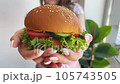 Woman hold in hamburger at home kitchen. 105743505