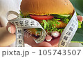 Woman hold in hamburger at home kitchen. 105743507