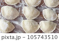 Traditional Ukrainian dish, dumplings sprinkled with flour, ready for cooking 105743510