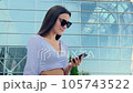 Business woman is talking on the phone on the background of an international airport 105743522