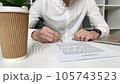 Young man reads and signs a contract in the office 105743523