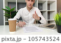 Young man reads and signs a contract in the office 105743524