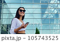 Business woman is talking on the phone on the background of an international airport 105743525