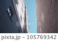 smooth passage through the two buildings, an upward view of the houses and the sky, a city vibe 105769342