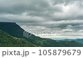 Time lapse of rain clouds wave rapidly over the densely forested mountains before the rain. 105879679