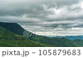 Time lapse of rain clouds wave rapidly over the densely forested mountains before the rain. 105879683