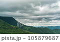 Time lapse of rain clouds wave rapidly over the densely forested mountains before the rain. 105879687