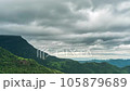Time lapse of rain clouds wave rapidly over the densely forested mountains before the rain. 105879689