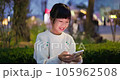 girl uses phone at night 105962508
