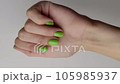 Beautiful womans hand with summer nail design on white background 105985937