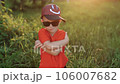 Portrait of little child kid boy looking at the camera with crossed arms at sunset. Ambitious young people. Younger generation. Lifestyle. 106007682