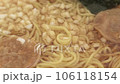 Picking up cup ramen noodles with chopsticks 106118154