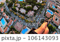 paraglider flying over roofs of houses with swimming pools and Smooth landing 106143093