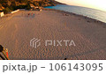 paraglider flying over the beach and Smooth landing in Oludeniz on sunset 106143095