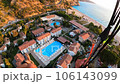 paraglider flying over roofs of houses with swimming pools and Smooth landing 106143099