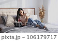 Happy beautiful woman in casual clothes talking on video call on digital tablet lying on the bed. Celebration valentines day dating on quarantine concept 106179717