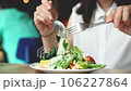 Woman eats vegetarian salad at restaurant. Healthy eating	 106227864
