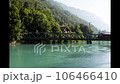 River and train flowing through a small town in Switzerland 106466410