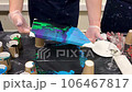 Fluid art. Flow abstract colourful paintings. Man hands pouring acrylic paint to canvas. High quality FullHD footage video. High quality FullHD footage 106467817