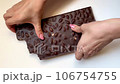 Woman hands breaking dark chocolate bars on white background. Top view nut snacks video. . High quality 4k footage 106754755