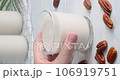 Hand taking a glass with vegan milk, Close-up video of non-dairy drink made of pecan nuts placed on white table, 4k video 106919751