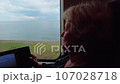 A woman goes on vacation to the Black Sea in the city of Sochi.  107028718