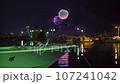 Two women are watching a fireworks display while being rocked by a boat at the port at night. 107241042