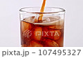 Pouring Coke in Glass With Ice Cubes 107495327
