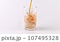 Pouring Coke in Glass With Ice Cubes 107495328