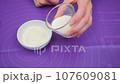 Adding warm cow's milk to cornstarch 107609081